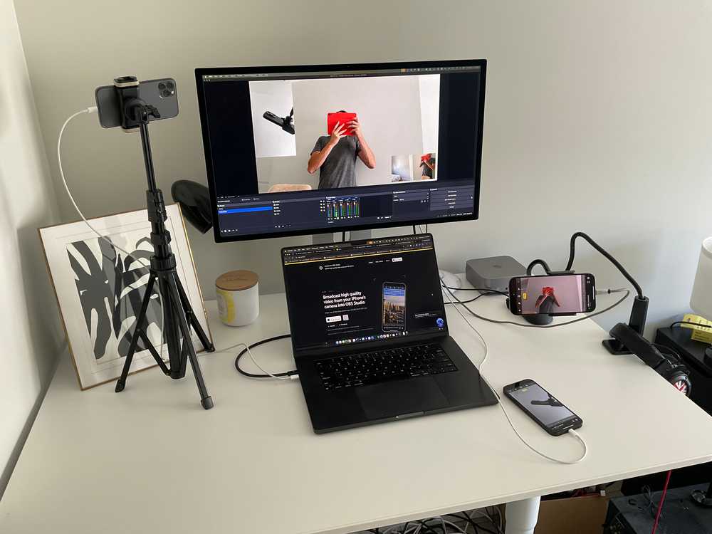 Three mounted iPhones connected to a computer running OBS Studio.